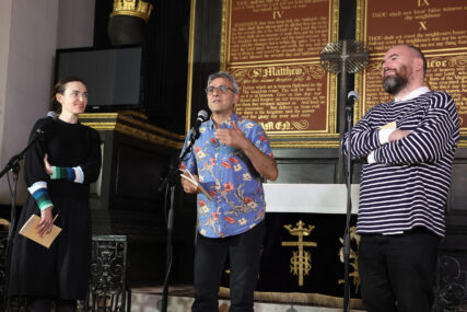 Three poets performing in a church Three poets performing in a church