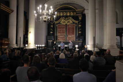 Three poets performing in a church Three poets performing in a church