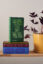 Stack of Faber Members Editions next to plant Stack of Faber Members Editions next to plant